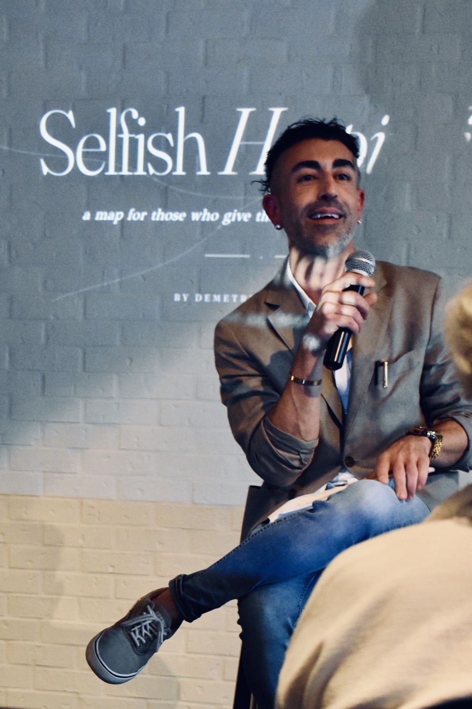 Demetri Gregorakis speaking at a Selfish Hospitality event.